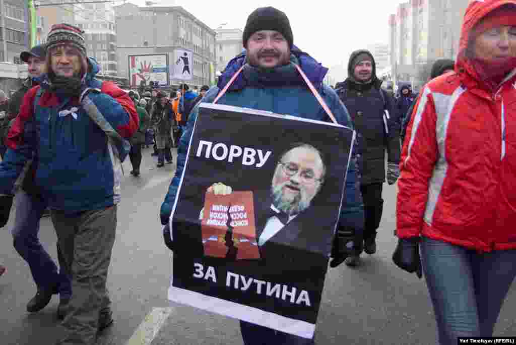 Central Election Commission head Vladimir Churov is pictured ripping up the constitution saying, "I tear up for Putin," a reference to the Putin Army -- attractive young women who tear off their clothes for Putin.