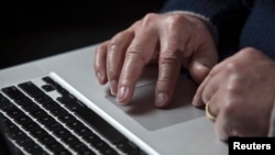 U.S. -- A cyber warfare expert works on his Apple laptop computer during a portrait session in Charlotte, North Carolina, 01Dec2011