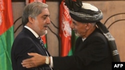 Newly-sworn in Afghan President Ashraf Ghani (R) embraces to Abdullah Abdullah, Afghan new Chief Executive, during the swearing in ceremony for the country's new president at the Presidential Palace in Kabul, September 29, 2014.