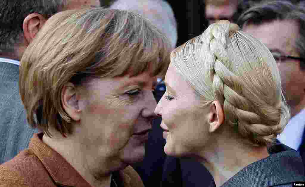 German Chancellor Angela Merkel (left) is greeted by Ukrainian opposition leader Yulia Tymoshenko after a meeting of the European People's Party in Meise, Belgium, in March 2011.