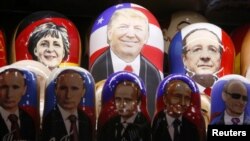 Russia -- Painted Matryoshka dolls, or Russian nesting dolls, bearing the faces of German Chancellor Angela Merkel, US Republican presidential nominee Donald Trump, French President Francois Hollande and Russian President Vladimir Putin are displayed for 