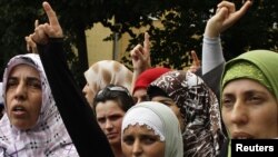 Muslim women protest against the government's decision to ban pupils from wearing head scarves in public schools.