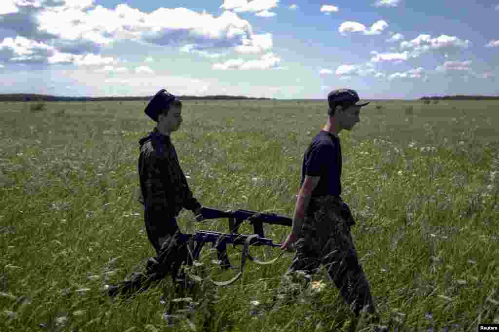 Students of the General Yermolov Cadet School carry their Kalashnikov automatic rifles as they attend a field training outside the southern Russian city of Stavropol. (Reuters/Eduard Kornienko)