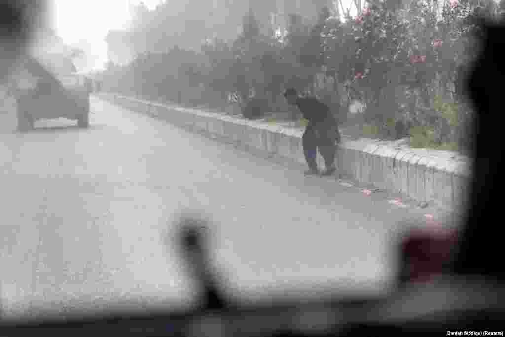 A civilian runs for cover amid a shoot-out that erupted as Afghan special forces neared the checkpoint where Shah was holed up. A Reuters photographer traveling with the convoy says gunfire appeared to come from both sides of the road before several RPGs were fired at the vehicles.&nbsp;