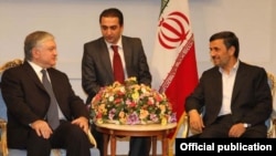 Iranian President Mahmud Ahmadinejad (right) with Armenian Foreign Minister Edward Nalbandian (left) in Tehran on September 17