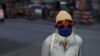 A man wearing a protective face mask walks along a road, as the outbreak of the coronavirus disease (COVID-19) continues in Karachi on June 2.