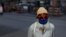 A man wearing a protective face mask walks along a road, as the outbreak of the coronavirus disease (COVID-19) continues in Karachi on June 2.