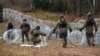 Polish soldiers lay razor wire along Poland's border with the Russian exclave of Kaliningrad in November 2022.