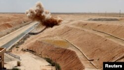 Syria -- Members of Kurdish Rojava Mine Control Organization destroy explosive devices planted by Islamic State militants near Ain Issa village north of Raqqa, June 20, 2017