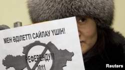 A pro-democracy activist holds a sign in front of the OSCE offices in Almaty in January that says, "I am for fair elections."