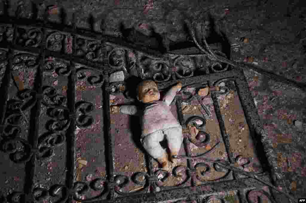 A doll lies on the ground at the entrance to a destroyed house following clashes between Macedonian police and an armed group in Kumanovo.