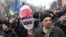 A protester carries a balloon with a picture showing Ukrainian President Petro Poroshenko and the words "Poroshenko is not my president" during a mass march and rally in Kyiv on February 18. 