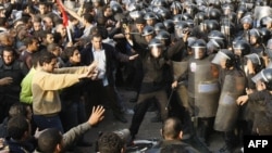 Demonstrators clash with police in central Cairo on January 25.