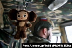 A Cheburashka keychain hangs in a Russian military vehicle in Ukraine's Luhansk region in January 2024.