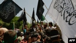 FILE: University students protest against the Elimination of Violence against Women law in Kabul in May 2013.