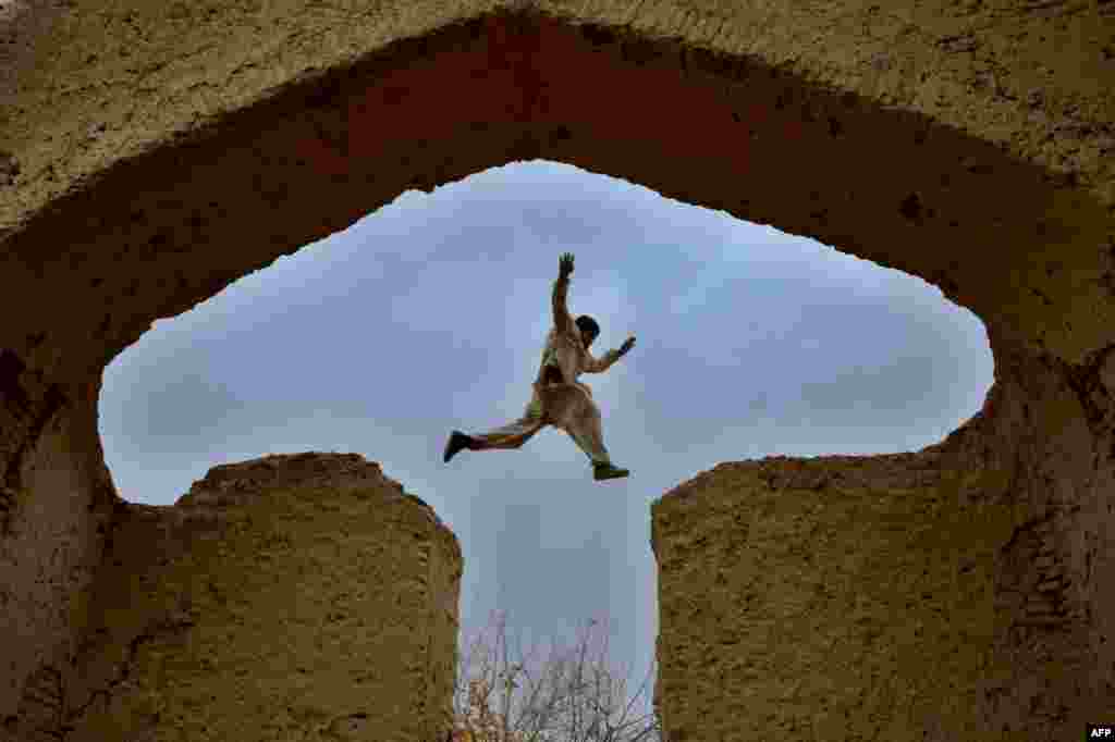 An Afghan boy plays in the ruins of a house that at one point belonged to the 13th-century Persian poet, Islamic scholar, and Sufi mystic, Jalal ad-Din Muhammad Rumi, on the outskirts of Mazar-e Sharif. (AFP/Farshad Usyan)