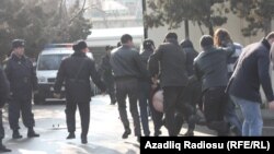 Police arrest two members of the band Bulistan at a youth opposition rally in Baku on March 17.