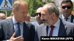 Armenia-- Armenian Prime Minister Nikol Pashinian and European Council President Donald Tusk walk in downtown Yerevan after their meeting on July 10, 2019. 