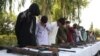 Former Taliban and IS militants surrender their weapons during a reconciliation ceremony in Jalalabad on August 28.