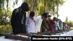 Former Taliban and IS militants surrender their weapons during a reconciliation ceremony in Jalalabad on August 28.