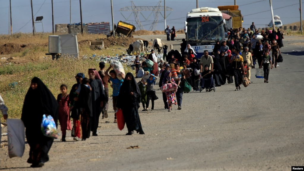Displaced people flee fighting in Mosul.