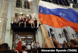 Fans celebrate Russia's victory in the 2018 FIFA World Cup Round of 16 match against Spain in Moscow.
