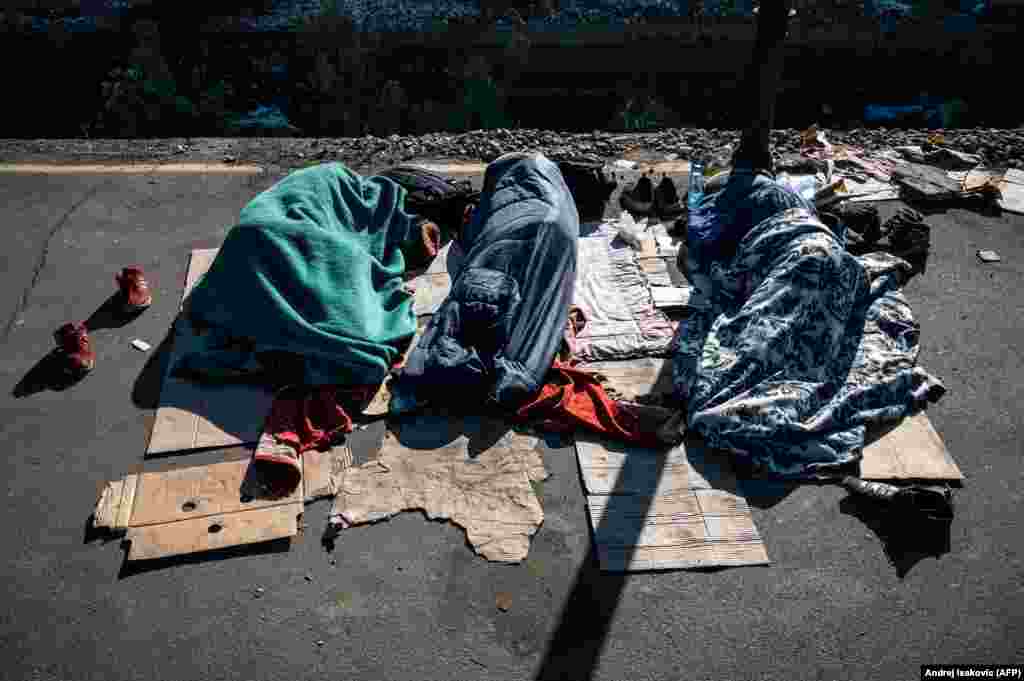 A group of Afghan migrants sleep on a deserted platform in Belgrade's former central station in Serbia. (AFP/Andrej Isakovic)