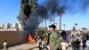 Hashd al-Shaabi (paramilitary forces) fighters set the U.S. Embassy wall on fire as they protest to condemn air strikes on their bases. December 31, 2019