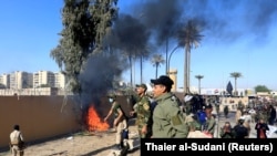 Hashd al-Shaabi (paramilitary forces) fighters set the U.S. Embassy wall on fire as they protest to condemn air strikes on their bases. December 31, 2019