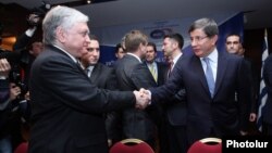 Armenia - Foreign Minister Edward Nalbandian (L) and his Turkish counterpart Ahmet Davutoglu shake hands before the start of a BSEC meeting in Yerevan, 12Dec2013.