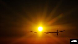 Switzerland -- Experimental aircraft "Solar Impulse" with pilot Andre Borschberg onboard flies at sunrise above Payerne's Swiss airbase on 08Jul2010