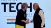 Britain's Prime Minister Theresa May shakes hands with her Indian counterpart Narendra Modi during the India-UK Tech Summit in New Delhi on November 7.