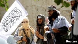 FILE: Taliban celebrate ceasefire in the eastern province of Nangarhar in June. 