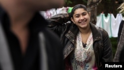 Leonarda Dibrani, 15, smiles as she walks in the town of Mitrovica on October 17, following her deportation from France.