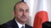 Turkey's Foreign Minister Mevlut Cavusoglu attends a press conference Tuesday, Nov. 6, 2018, in Tokyo. Turkey’s top diplomat has criticized the U.S. resumption of sanctions on Iran as unilateral, not wise and dangerous, calling for a dialogue and compromi