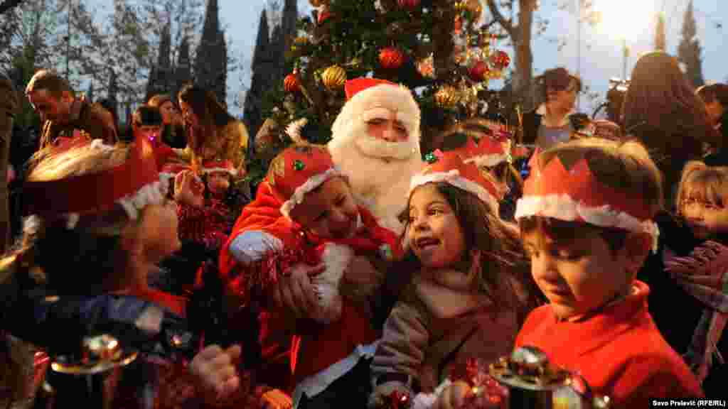 Santa Claus and children at a humanitarian event for mothers with children in Montenegro. (RFE/RL's Savo Prelevic)