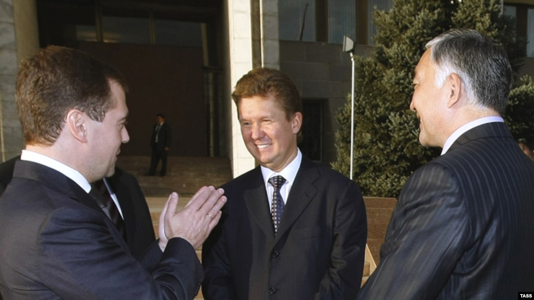 Russian President Dmitry Medvedev (left) and Gazprom's Aleksei Miller (center) seal the deal in Bishkek.