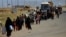 Displaced people flee fighting in Mosul.