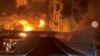 Fire burns and smoke rises from Aqdasieh Oil Depot in Tehran