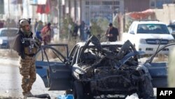 FILE: A soldier stands next to the site of a suicide attack in Kabul on November 13