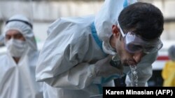 Armenia -- A medical worker drinks water at the yard of the Grigor Lusavorich Medical Center in Yerevan, June 9, 2020