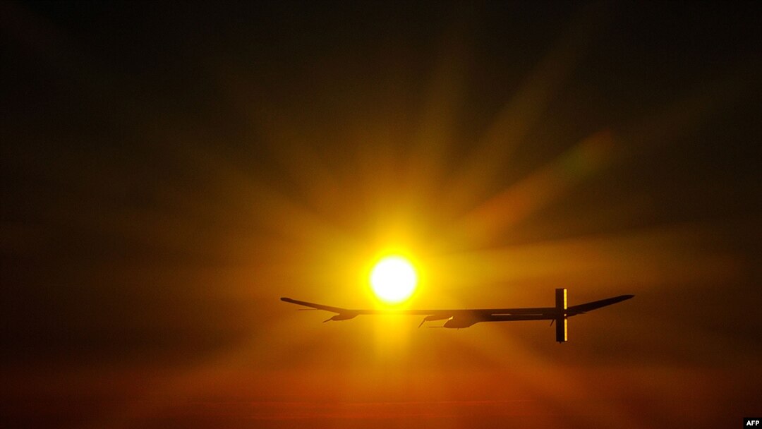 Switzerland -- Experimental aircraft "Solar Impulse" with pilot Andre Borschberg onboard flies at sunrise above Payerne's Swiss airbase on 08Jul2010