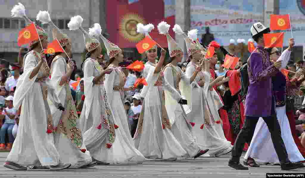 Kyrgyz women in traditional dress walk in central Bishkek.&nbsp;