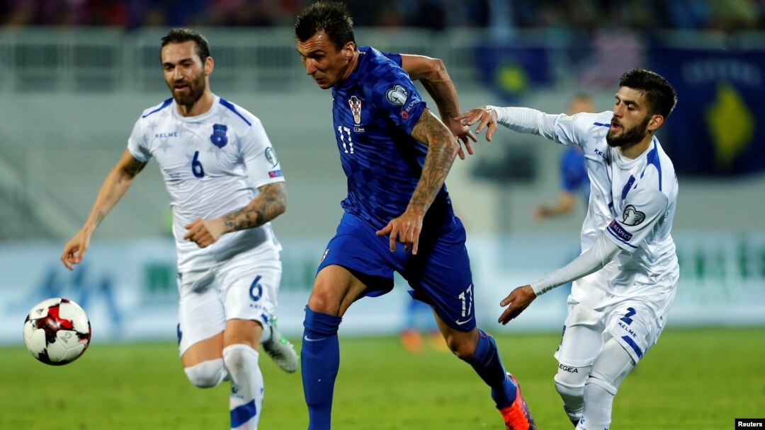 Two Kosovar players (in white) attempt to close down a Croatian forward during Kosovo's qualifying match for the 2018 World Cup last year. 