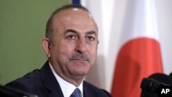 Turkey's Foreign Minister Mevlut Cavusoglu attends a press conference Tuesday, Nov. 6, 2018, in Tokyo. Turkey’s top diplomat has criticized the U.S. resumption of sanctions on Iran as unilateral, not wise and dangerous, calling for a dialogue and compromi