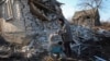 Resident Natalia collects her granddaughter's toys that were scattered around her home hit by a Russian air strike in the town of Kostiantynivka, Ukraine, on February 9.