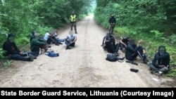 Migrants apprehended by Lithuanian authorities on a forest road near the Belarusian border on July 1.