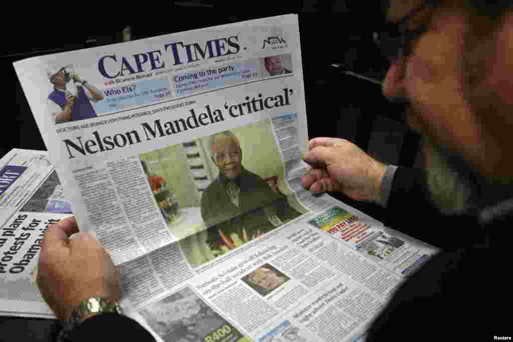 South Africa -- A man reads a newspaper in Cape Town, 24Jun2013