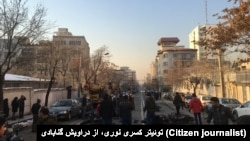 The aftermath of security forces attacking Dervishes in Tehran in February 2018. Street is littered with motorbikes and debris. 