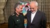 Islamic Revolutionary Guard Corps (IRGC) commander Mohammad Ali Jafari (L) and Iranian Foreign Minister Mohammad Javad Zarif smile during a meeting in Tehran, October 9, 2017